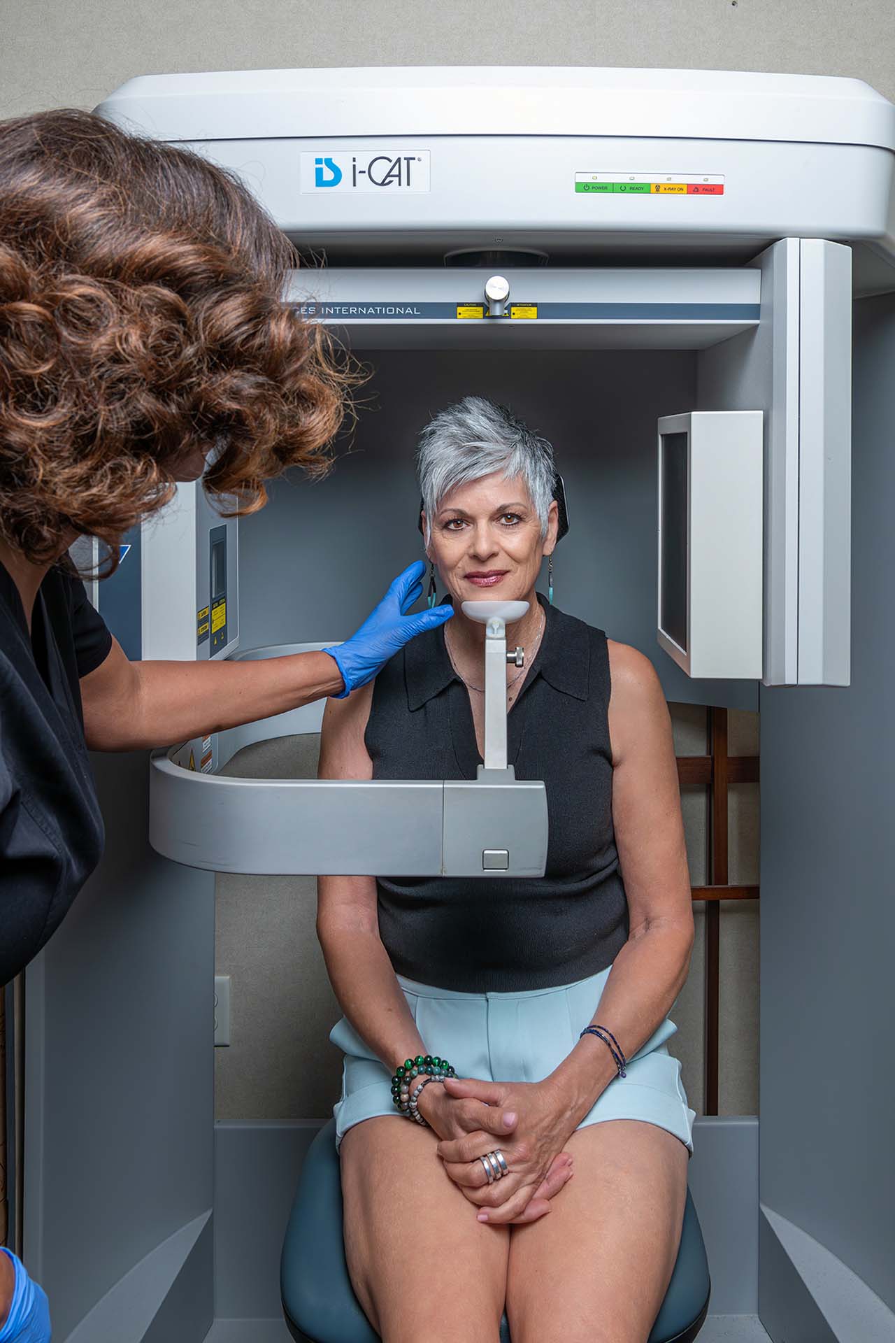 A patient at Kelleher Orthodontics is being prepared for a dental radiograph, showing the 3D imaging process.